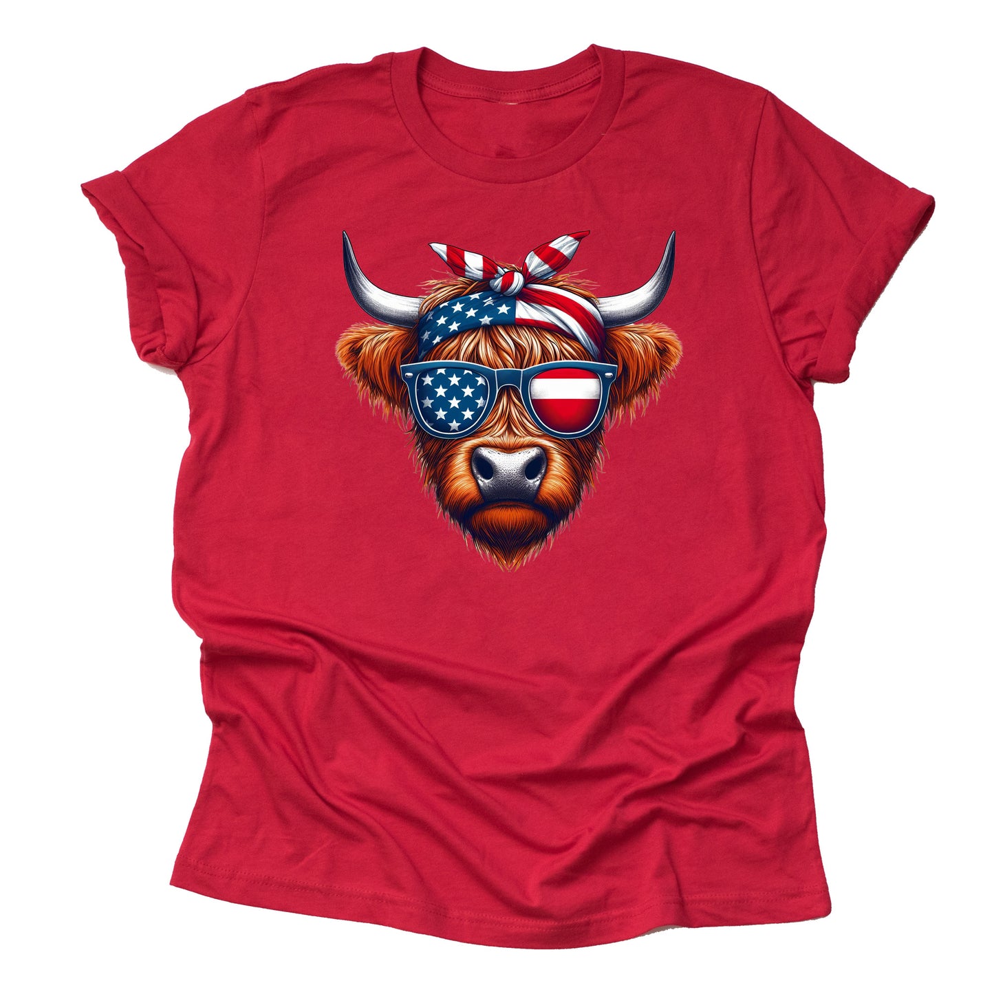 A red short-sleeved unisex T-shirt featuring a graphic of a Highland cow with American flag patterned sunglasses and a bow.