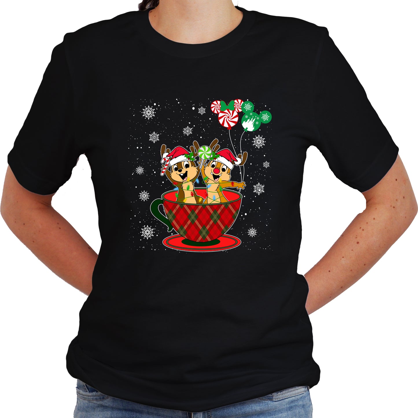 A women wearing black unisex t-shirt with a graphic design featuring Chip and Dale in a Christmas themed setting, including a cup and balloons.