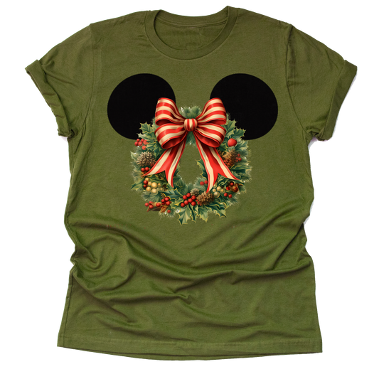 Women's olive t-shirt featuring a graphic of Minnie Mouse ears with a Christmas flower wreath and a red and white striped bow.