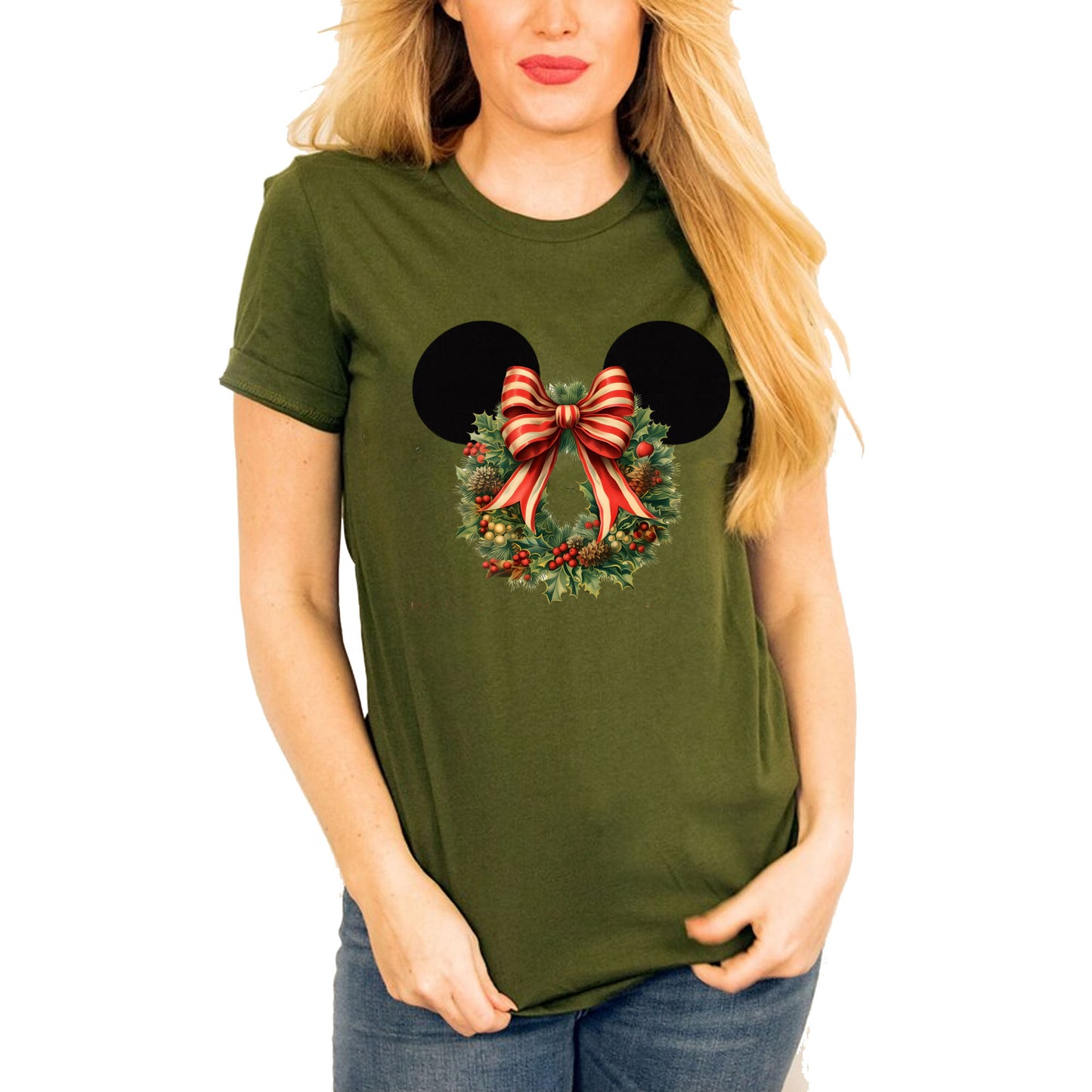 Women wearing olive t-shirt featuring a graphic of Minnie Mouse ears with a Christmas flower wreath and a red and white striped bow.
