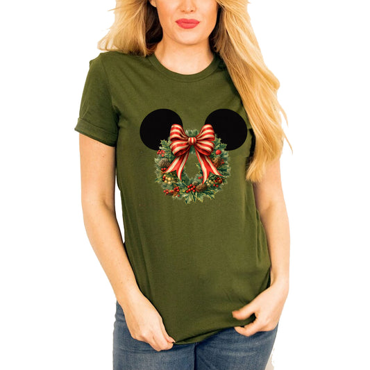 Women wearing olive t-shirt featuring a graphic of Minnie Mouse ears with a Christmas flower wreath and a red and white striped bow.