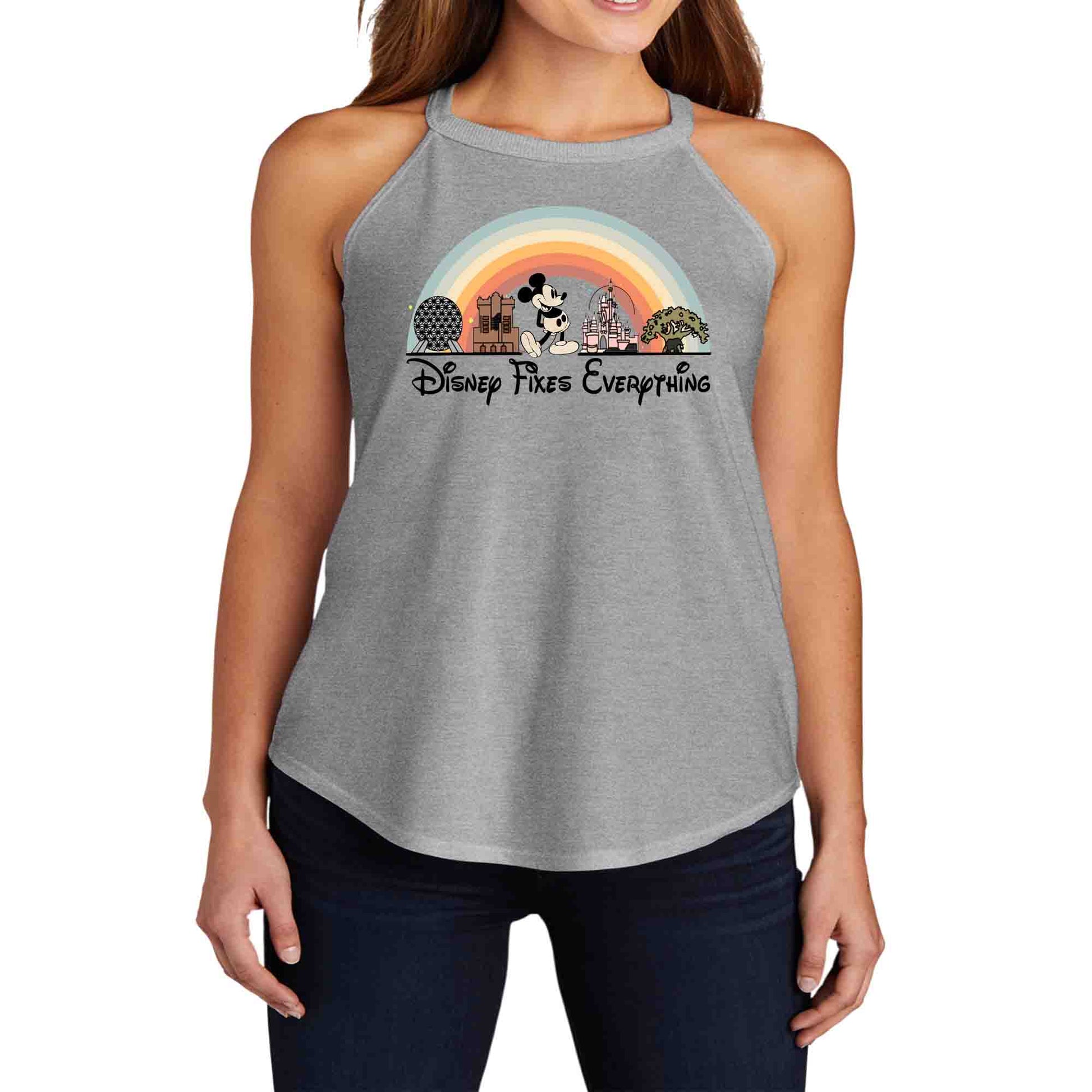 A gray short sleeve female wearing tank top with a graphic that includes Disney park icons and the text 'Disney Fixes Everything' in a rainbow-colored arch.