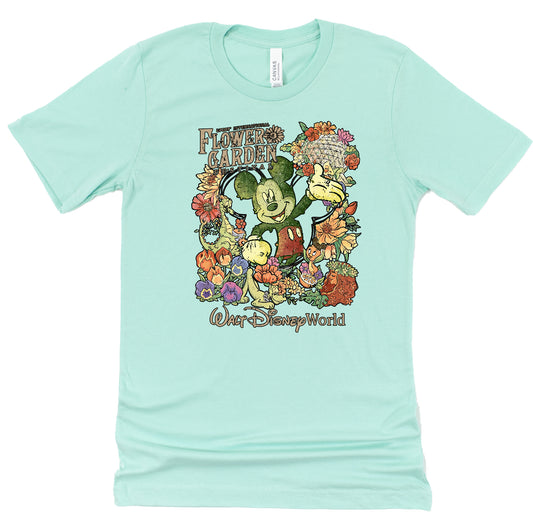 Mint green t-shirt with Disney mickey character and floral design on a white background