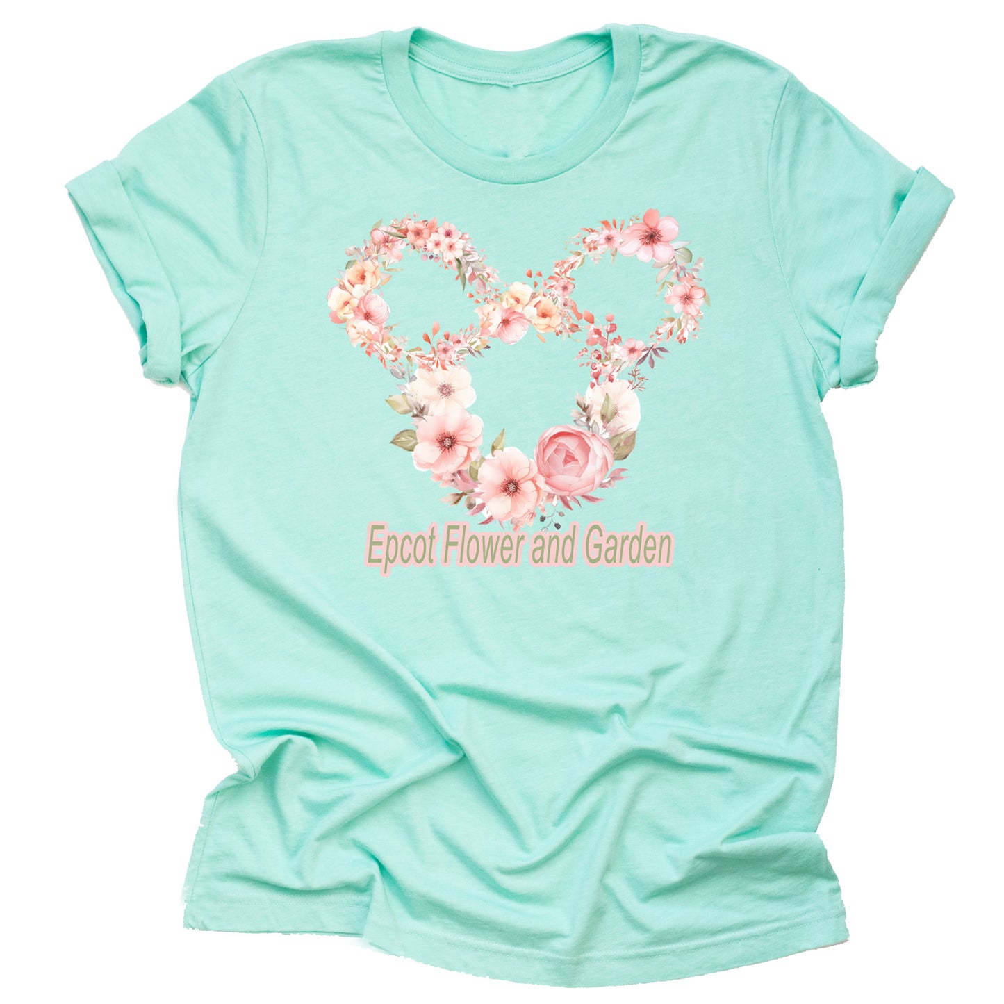 A short-sleeved unisex t-shirt in a mint color, featuring floral graphics arranged in the shape of mickey with the Epcot logo with the text 'Epcot Flower and Garden' on the front.