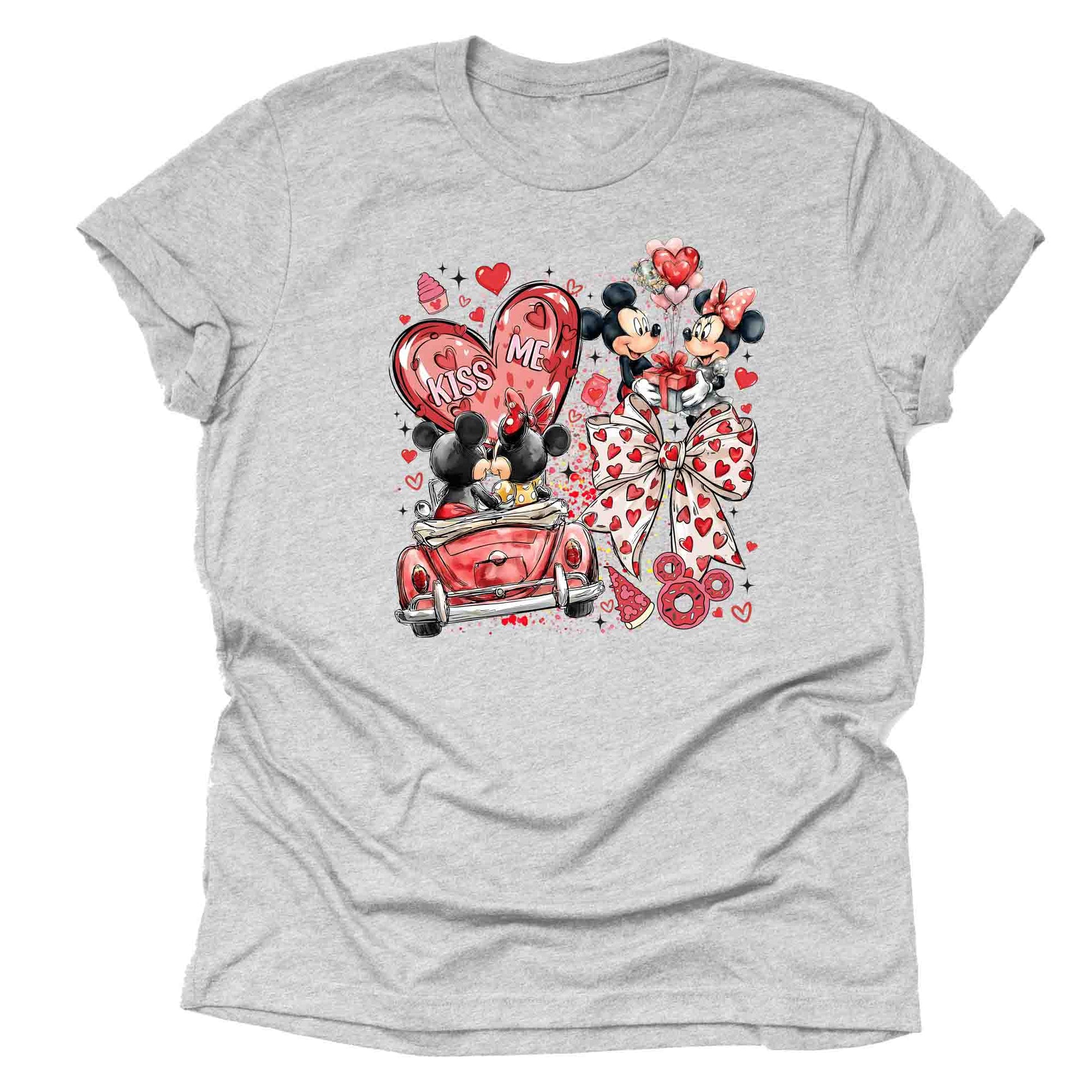 Gray t-shirt Valentine-themed with mickey and minnie cartoon in a car characters with big bow and the text 'Kiss Me" and heart designs on a white background