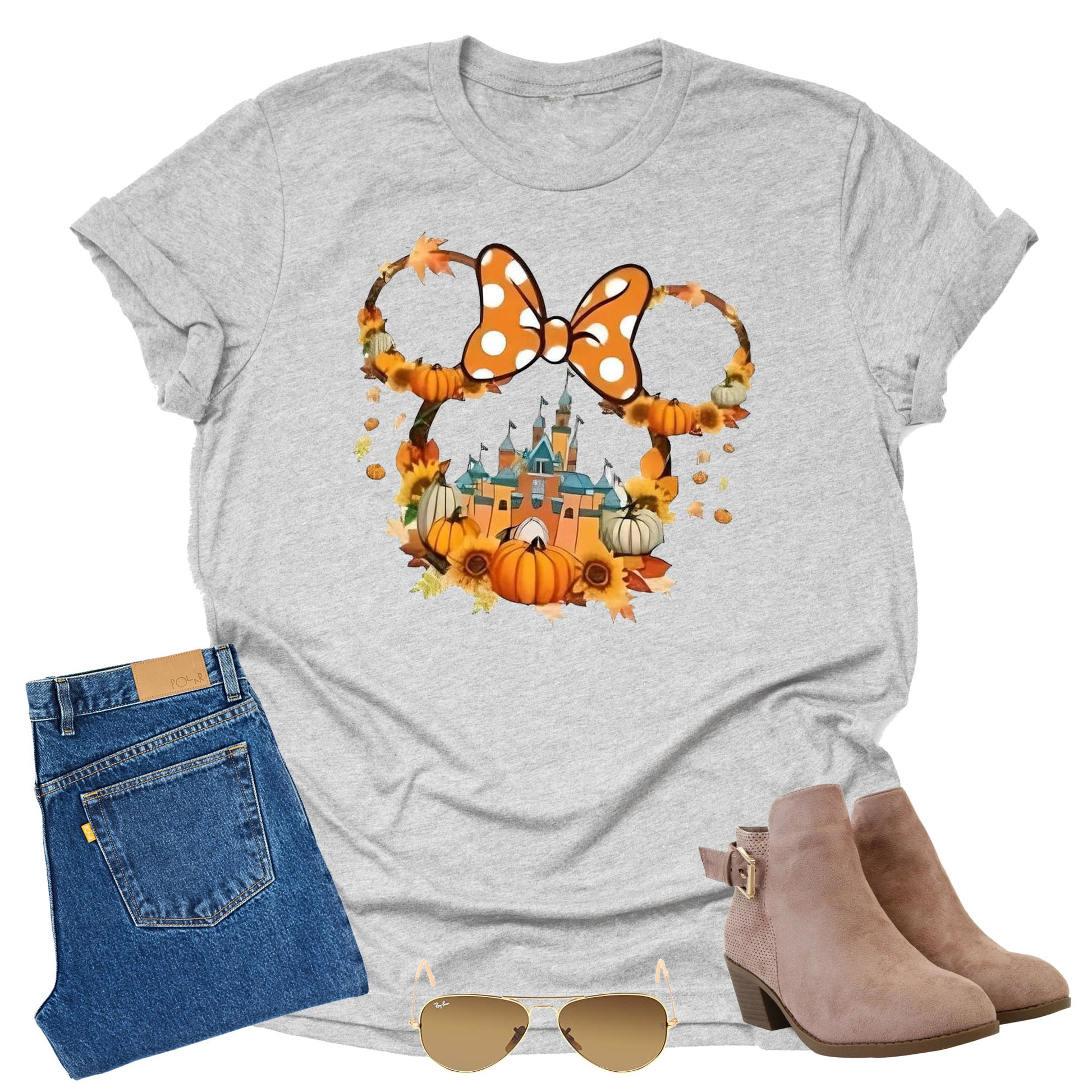 Gray t-shirt with Halloween-themed  minnie with bow and pumpkins and castle design, paired with jeans, boots, and sunglasses on a white background.